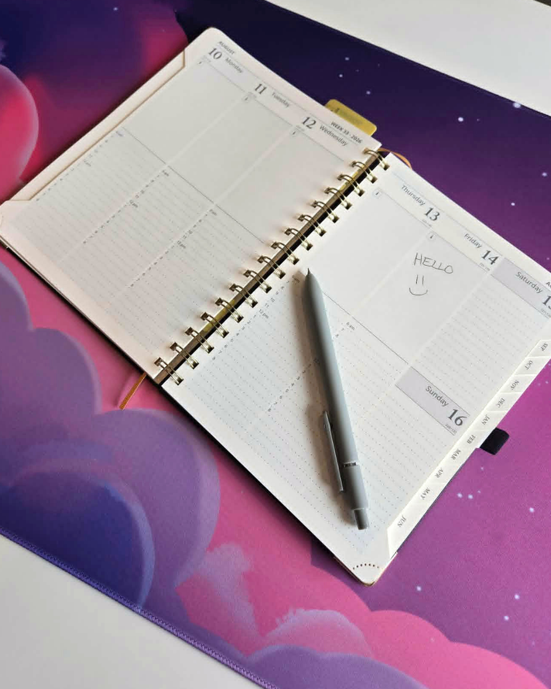 Open planner with a pen on a colorful background