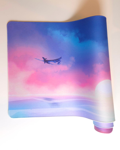 Mouse pad with a dragon design on a colorful sky background