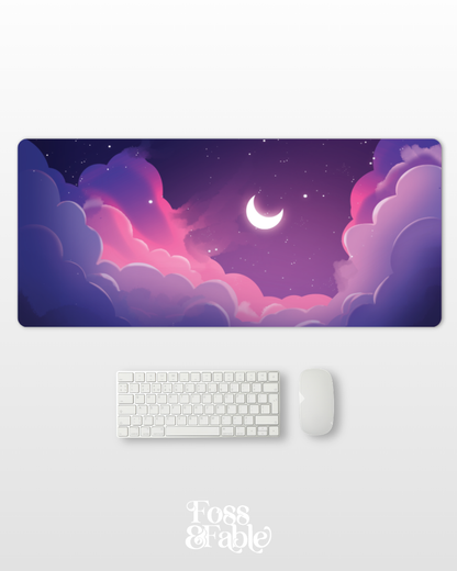 Desk setup with a decorative mouse pad featuring a night sky design, keyboard, and mouse on a white background.