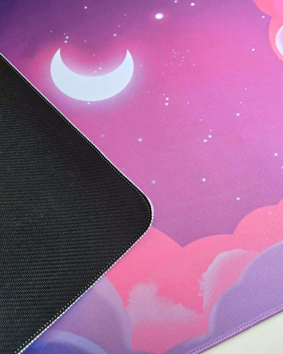 Mouse pad with a pink sky and moon design